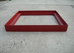 Riser for grate covers, a flat red steel rectangular frame