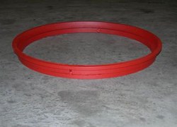 Type III solid manhole riser, a low-profile red steel ring